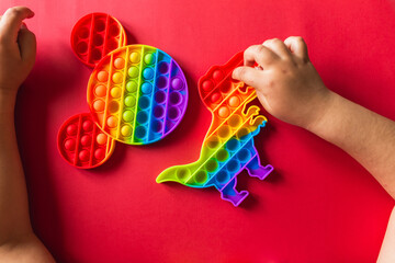 A child plays with a flapping fidget. popular children's flexible sensory toy develops fine motor skills, anti-stress, can be used for training with autistic people, popit toy
