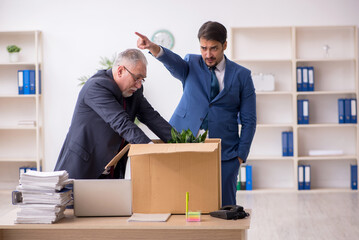 Two male employees in dismissal concept
