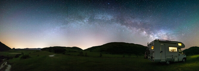 Panoramic night sky over Montelago highlands, Marche, Italy. The Milky Way galaxy arc and stars...