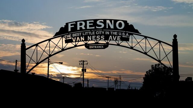 Fresno Archway Sign, Time Lapse at Sunrise with Colorful Clouds, California. USA