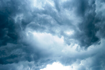 Thick dark black storm clouds covering summer sunset sky with gale-speed wind blowing just before Nor'westers Kalbaishakhi Bordoisila thunderstorm torrential rain. Atmospheric Texture background.