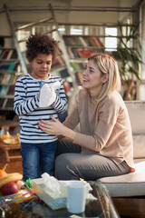 Happy caucasian nanny babysitting afro american boy