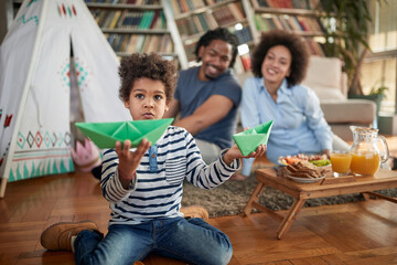 A little boy spending quality time with his parents at home. Family, home, together, playtime