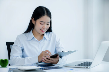 Businesswoman analysis the chart with laptop at the home office for setting challenging business goals And planning to achieve the new target