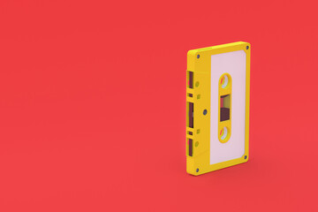 Single vintage audio cassette tape of yellow color on red background. Music storage. Retro cartridge. Copy space. 3d render