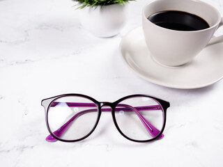 Closeup glasses coffee cup with flower vase on the marble table background copy space morning