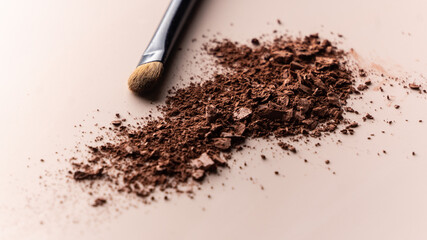 broken eye shadow scattered across the smooth pink surface. Texture background, advertising the structure of cosmetics. macro, copyspace