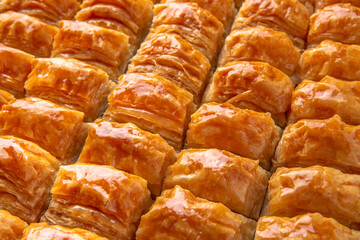 Turkish desert baklava with peanut, pistachio for holiday or ramadan. Traditional Middle Eastern Flavors. Selective focus, pattern.