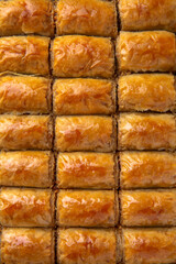 Turkish desert baklava with peanut, pistachio for holiday or ramadan. Traditional Middle Eastern Flavors. Selective focus, pattern.