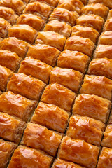 Turkish desert baklava with peanut, pistachio for holiday or ramadan. Traditional Middle Eastern Flavors. Selective focus, pattern.