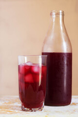 Red fruits iced tea with ice cubs