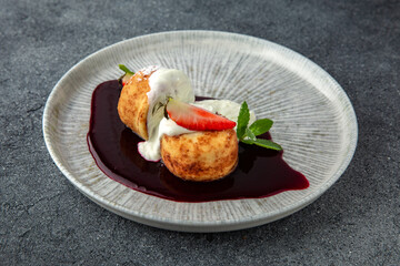 Lush cheesecakes with strawberries, peaches, cream and fruit jam. Healthy nutritious breakfast. Ready menu for the restaurant. Neutral gray blue textured background