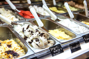 various italian gelato ice cream flavours in modern shop display window
