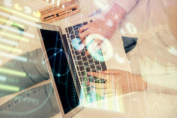 Double exposure of woman hands working on computer and data theme hologram drawing. Top View. Technology concept.
