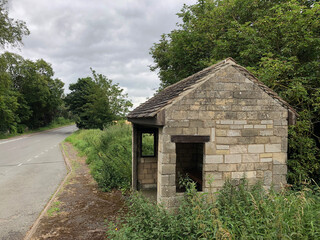 Fototapeta na wymiar stone bus stop on a country lane in UK