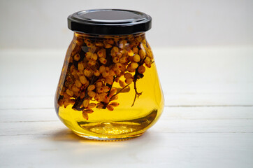 A glass jar with honey and herbs. Healthy eating and veganism