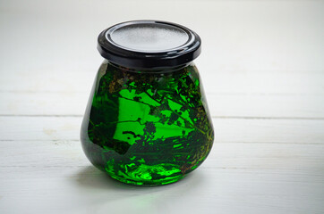 A glass jar with honey and herbs. Healthy eating and veganism