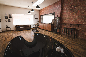 vintage barbershop salon with a hairdressing chair, a chester and a mirror, from a head washer