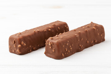 Two chocolate ice cream bars on white background close up macro shot