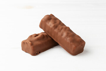 Two chocolate ice cream bars on white background close up macro shot