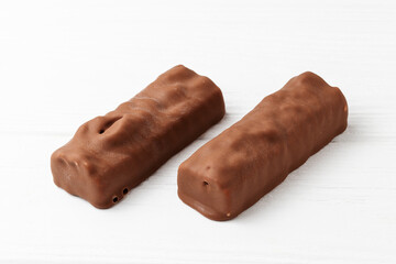 Two chocolate ice cream bars on white background close up macro shot