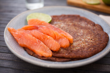 salted salmon fillet with buckwheat pancakes and lime