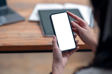 Cropped shot of woman hands holding blank screen smartphone with copy space.