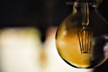 Art lives anywhere. I found an old lamp (woody colour) added to the blurred background (sunlight). Brazil, 2021 