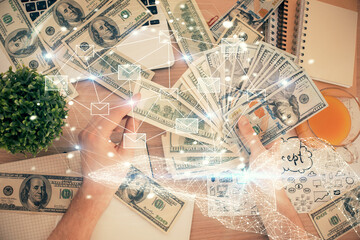 Multi exposure of envelop drawing hologram and USA dollars bills and man hands. Technology concept.
