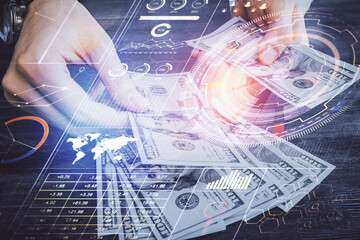 Multi exposure of technology drawing hologram and us dollars bills and man hands. Data concept