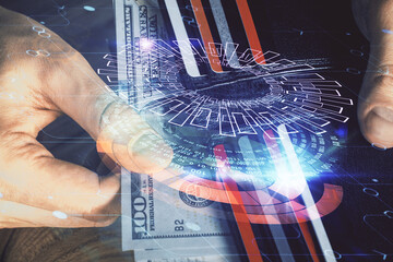 Double exposure of technology drawing hologram and us dollars bills and man hands. Data concept