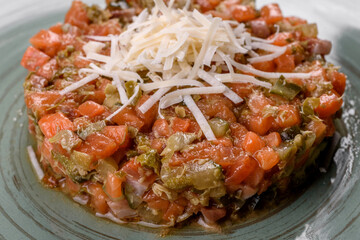 Raw salmon tartare. Fresh salmon, avocado and arugula salad in a culinary ring