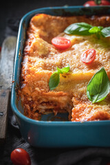 Homemade lasagna with bechamel and bolognese sauce. Roasting in casserole.
