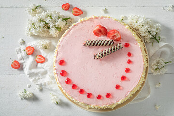 Sweet strawberry cake with summer flowers. Summer fruit cake.
