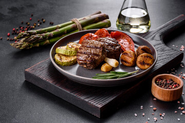 Tasty baked beef medallion with vegetables, mushrooms and spices