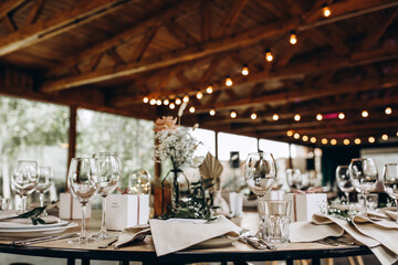 Wedding table setting and decoration. Cutlery on the table. Flower decoration of the banquet hall.