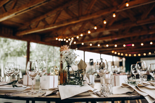 Wedding table setting and decoration. Cutlery on the table. Flower decoration of the banquet hall.
