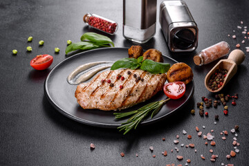 Tasty baked beef steak with vegetables, french fries and spices