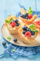 Delicious phyllo cups made of cream and beries. Summer dessert.