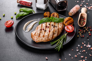 Tasty baked beef steak with vegetables, french fries and spices