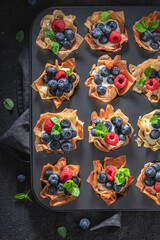 Delicious phyllo cups with blueberries and raspberries. Summer dessert.