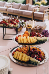 Dishes with berries and exotic fruits. Fruit salad. Dessert on the festive table.