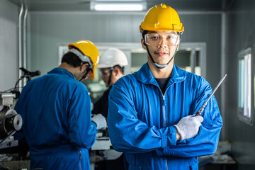 Asian technicians mechanical worker male crossed arm, work in factory.