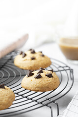 Delicious Whole Wheat Chocolate Chip Cookies set on white cafe table.