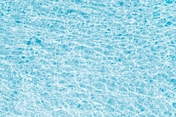 Swimming pool water surface background. Blue, bright and rippled water surface texture