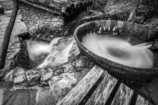 Black and white long exposure with motion blurred water at Etara, Bulgaria. Ancient equipment for washing carpets and other big textile surfaces.