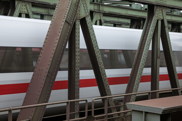 Naklejka premium Passenger high-speed train passes by the station Veddel in Hamburg
