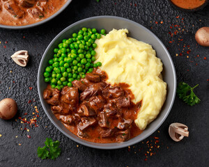 Slow Cooked Steak Diane Casserole with mushroom. mashed potatoes and green peas