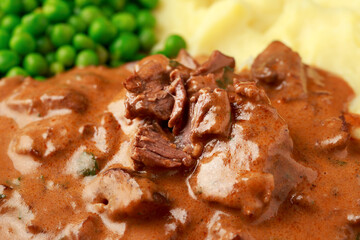 Slow Cooked Steak Diane Casserole with mushroom. mashed potatoes and green peas
