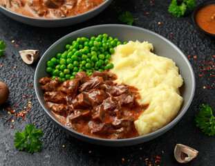 Slow Cooked Steak Diane Casserole with mushroom. mashed potatoes and green peas